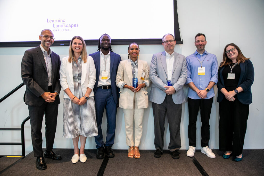 Grand-prize winners New Visions for Public Schools and Xchange Chicago pose with Joshua Elder of Siegel Family Endowment and Jamie Jutila of the Walton Family Foundation.